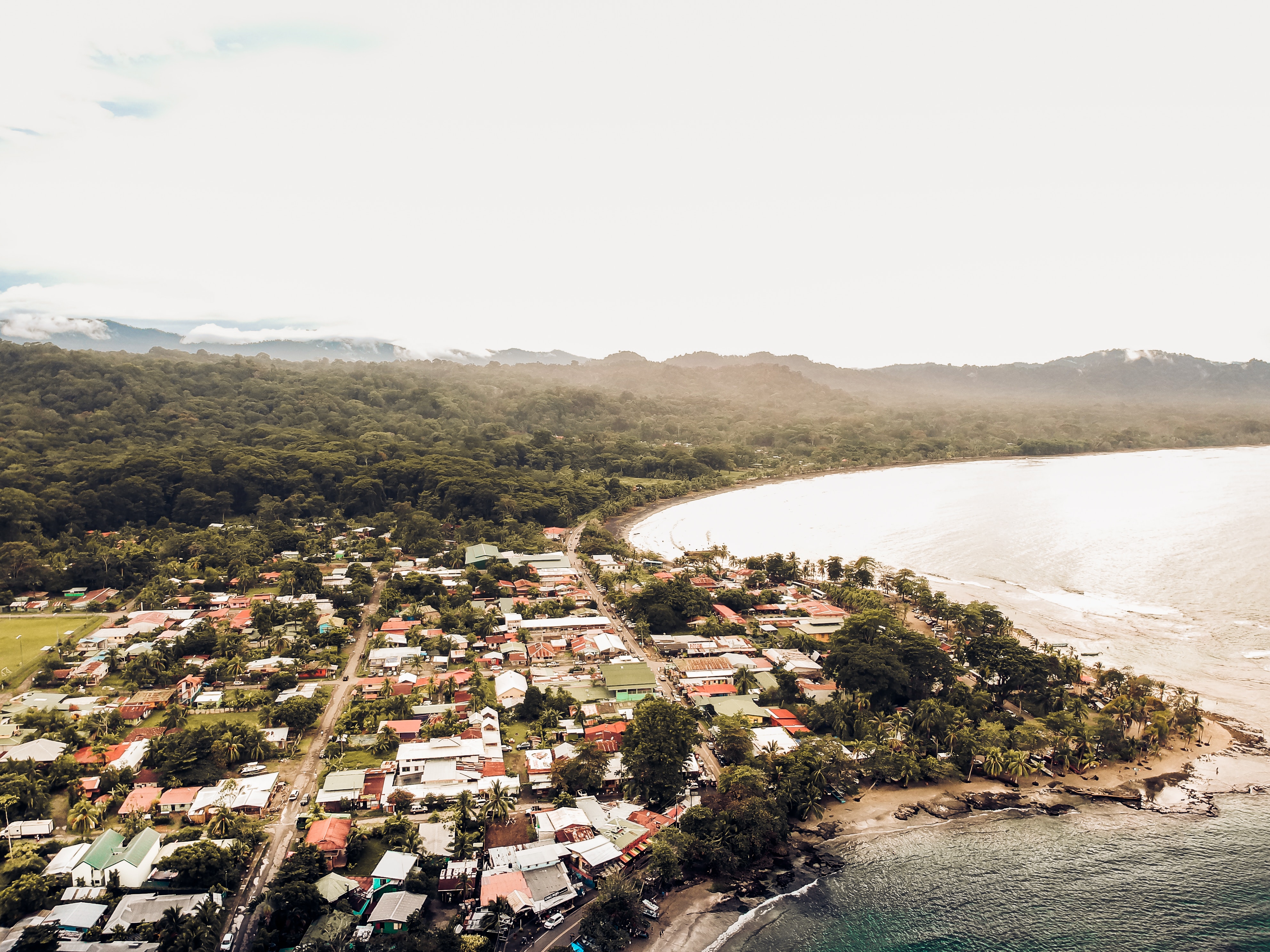 Aerial view of houses besides an ocean