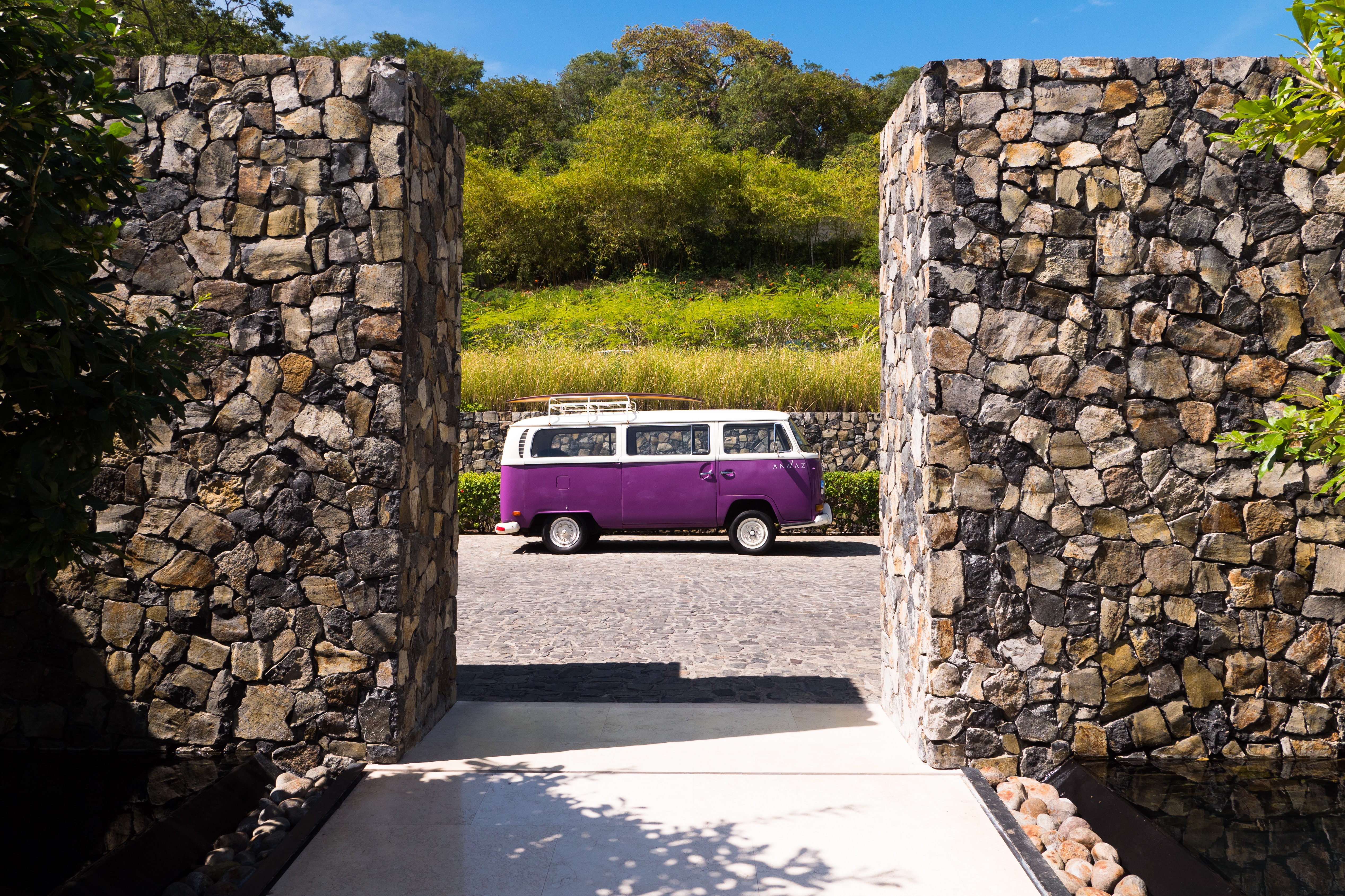white and pruple van parked near stone work during day time in Costa Rica scenary